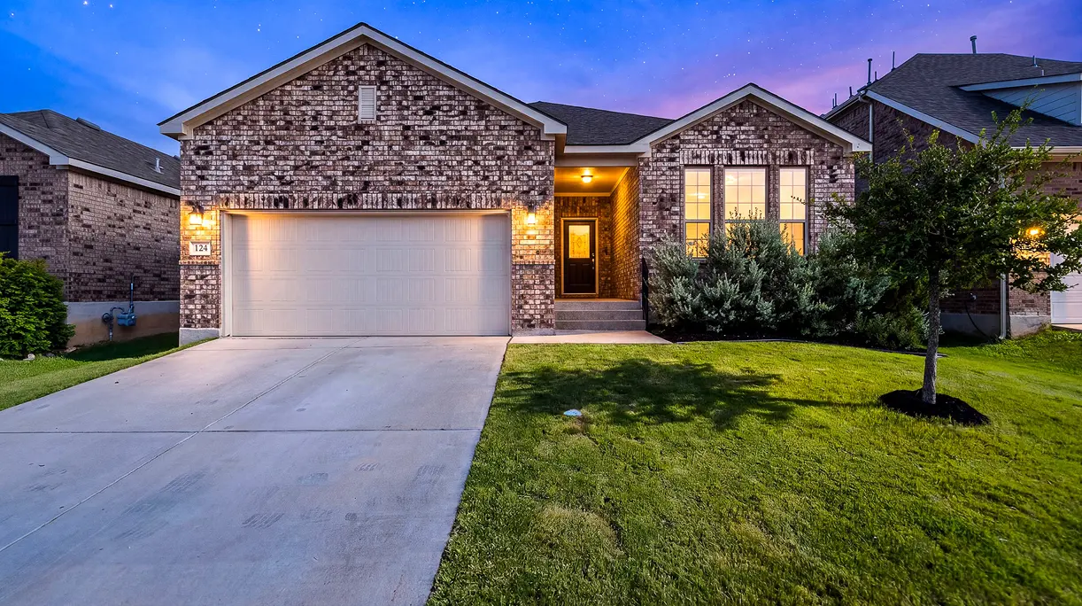 Twilight front exterior of 124 Wickersham, a beautifully maintained one-owner home for sale in the Southglen community of Boerne, TX.